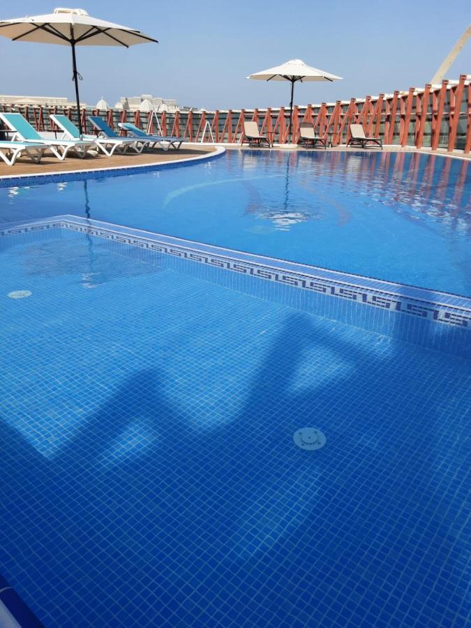 Cielo Hotel Lusail Qatar Exterior photo Swimming pool with blue mosaic tiles